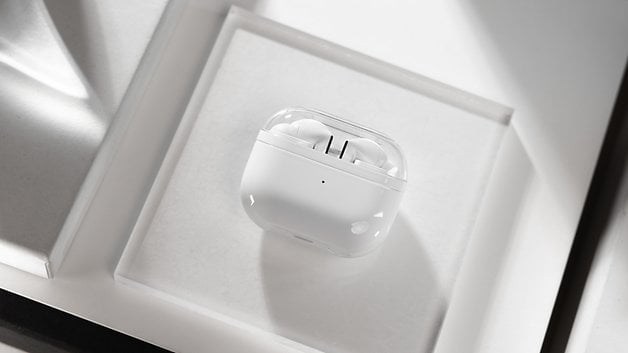 The Samsung Galaxy Buds 3 Pro charging case seen from above and placed on a glass plate.