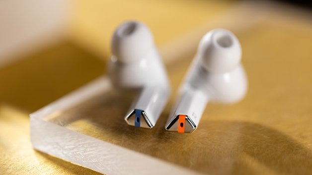 The Samsung Galaxy Buds 3 Pro seen from below with colored markings at the base of their stems.