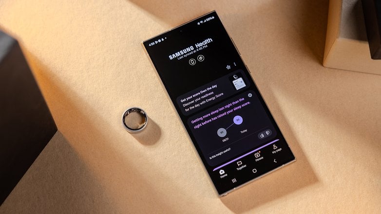 A Samsung Galaxy phone displaying the Samsung Health app next to a Galaxy Ring.