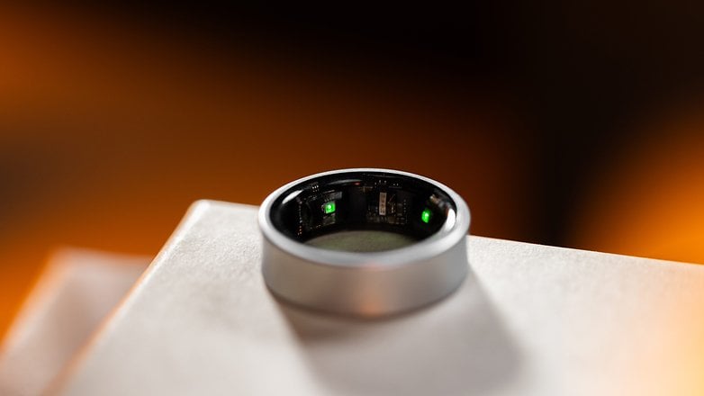 Close-up of a Samsung Galaxy Ring, showing its inner components and a green light.