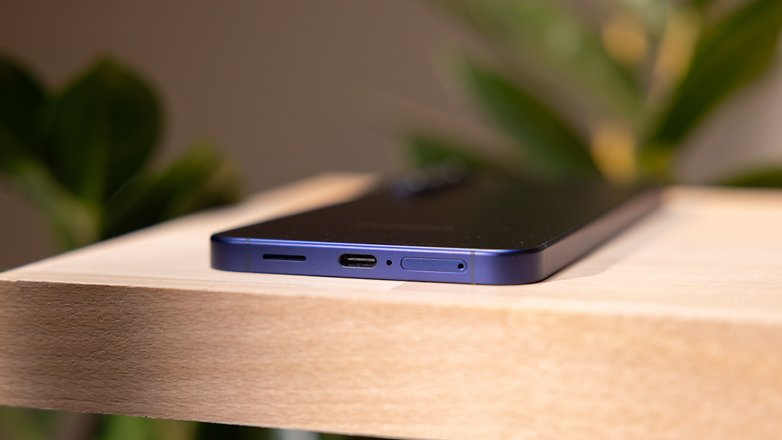 Close-up of a Samsung Galaxy S25 Plus smartphone on a wooden surface.