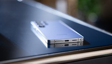 A Samsung Galaxy S25 Ultra smartphone resting on a reflective surface.