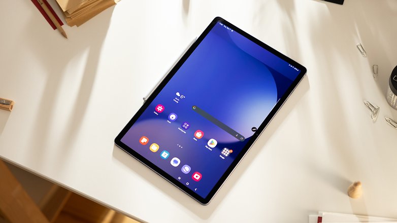 A Samsung Galaxy Tab S10+ displayed on a desk with various app icons on the screen.