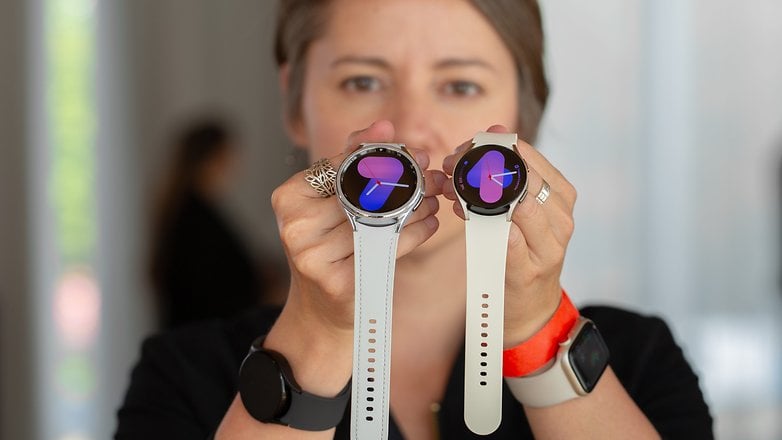 A person holding the Samsung Galaxy Watch 6 and Watch 6 Classic side by side