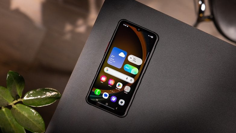Samsung Galaxy XCover 7 Pro smartphone on a black surface with app icons displayed. Samsung Galaxy XCover 7 Pro smartphone on a black surface with app icons displayed.