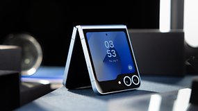 A half folded Samsung Galaxy Z Flip 6 in the standing position on a table