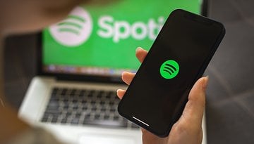 Ein Smartphone, auf dem das Spotify-Logo zu sehen ist.