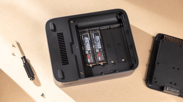 Open UGREEN Nasync DXP480T Plus enclosure with SSDs inside and screwdriver next to it.