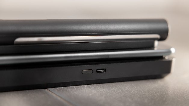 A close-up of a sleek black device with a USB-C port and a power button.