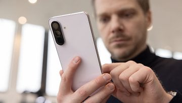 A person holding a Samsung Galaxy A56 smartphone, focused on the device.