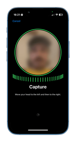 A smartphone screen displaying a face capture instruction with a blurred image.