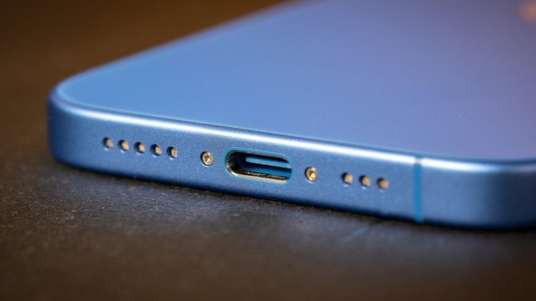 Close-up of an Apple iPhone 16 showing the USB-C charging port.