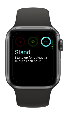 An Apple Watch SE 3 displays the message 'Stand: Stand for at least one minute every hour.'