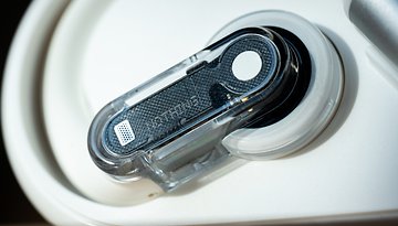 Close-up of Nothing Ear Open wireless earbuds with a transparent casing.