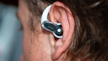 Close-up of a Nothing Ear Open wireless earbud in a person's ear.