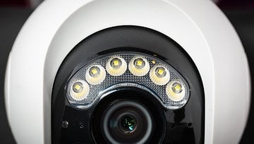 Close-up of a Reolink Atlas PT Ultra security camera featuring LED lights around the lens.