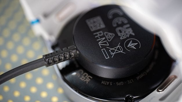 Close-up of the Samsung Galaxy Watch 7 charging station with its cable connected.