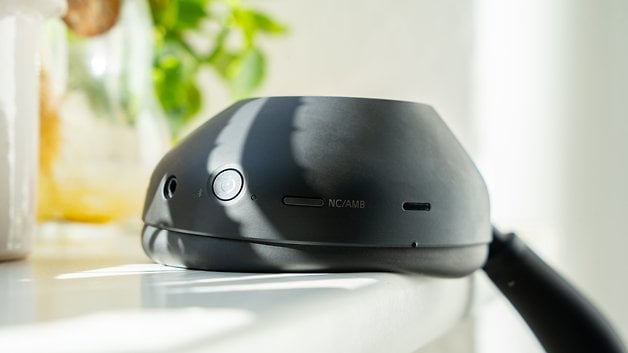 Close-up of the Sony WH-1000XM6 headphones, showing its buttons and sleek design.