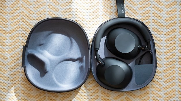 A pair of Sony WH-1000XM6 headphones in a protective case.