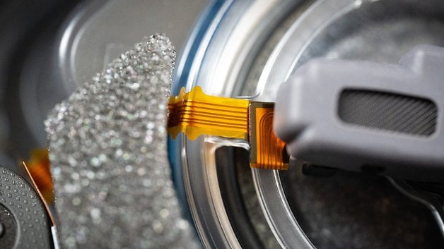 Close-up of electronic components in Sony WH-1000XM6 headphones.
