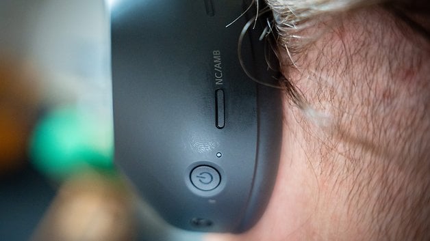 Close-up of a Sony WH-1000XM6 headphone showing the control buttons on the side.