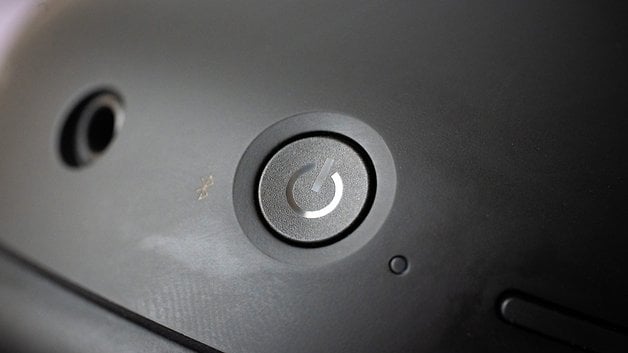 Close-up of the power button on the Sony WH-1000XM6 headphones.