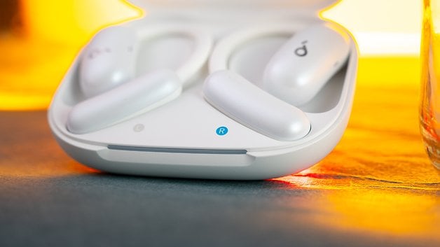 Soundcore Aerofit 2 earbuds in their charging case with an illuminated indicator.