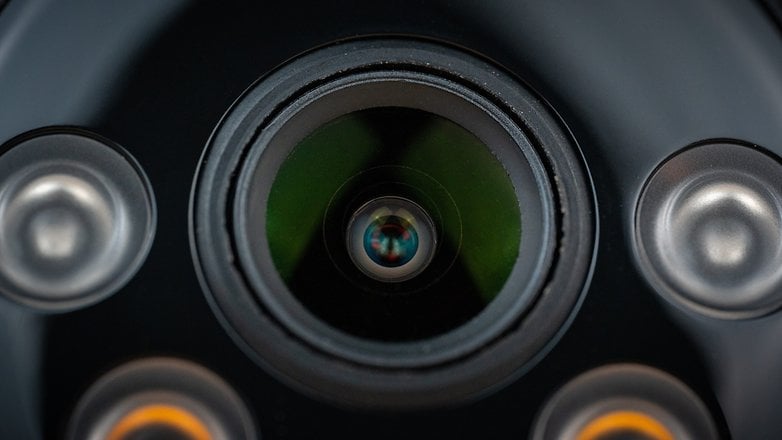 Close-up of a camera lens showing intricate details and reflections.