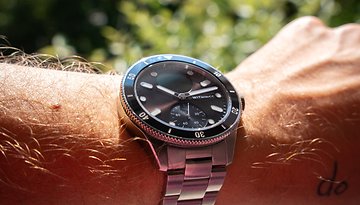Eine Nahaufnahme der Withings ScanWatch Nova an einem Handgelenk mit Haaren und Sonnenlicht im Hintergrund.