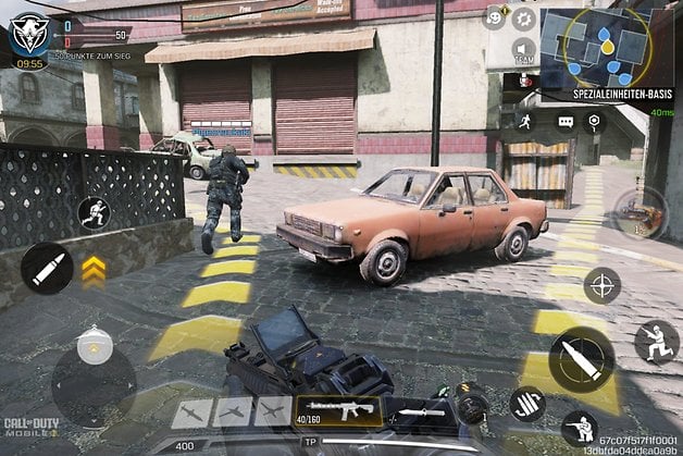 A soldier runs towards a building while approaching a parked car in a game.