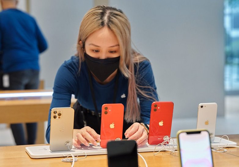 iPhone models displayed on an Apple Store