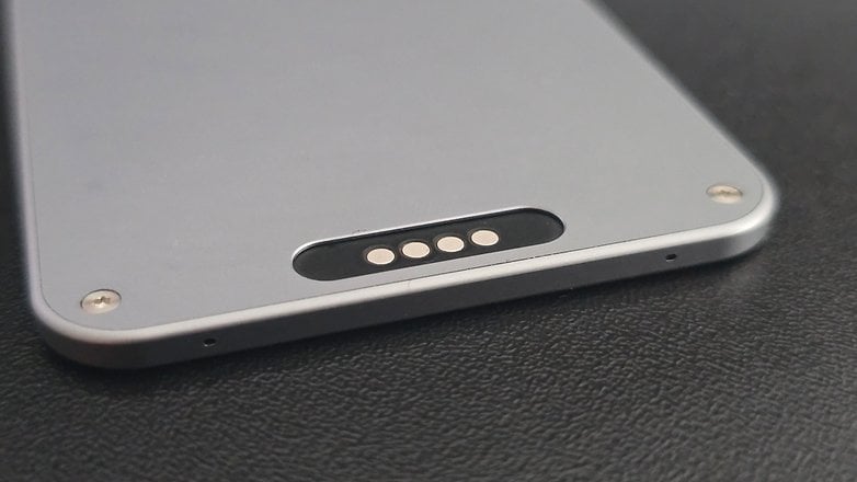 You can charge via the included USB-C cable at this port on the back of the card.