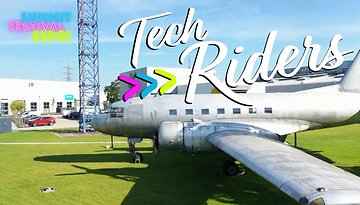 Ein Vintage-Flugzeug auf grünem Gras mit dem Text 'Tech Riders' und Veranstaltungsdetails darüber.