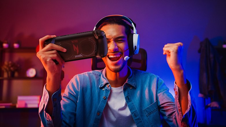 Gamer holding the Acer Nitro Blaze 7 in one hand while celebrating a win