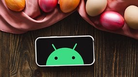 Android Robot on a phone with decorated Easter Eggs