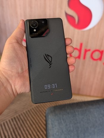 A hand holding an Asus ROG Phone 9 with a visible camera module and the time displayed as 09:31.