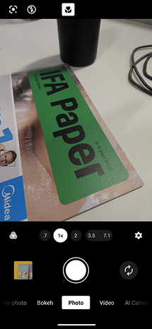 Screenshot of the Sony Xperia 1 VII camera app in Photo mode displaying a green 'IFA Paper' and a black cup.