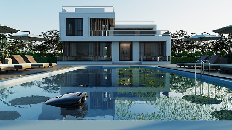 Ein modernes Haus mit einem Pool; ein roboter Cleaner ist im Wasser.