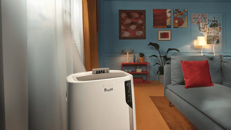 Eine DeLonghi Pinguino mobile Klimaanlage in einem stilvollen Raum mit blauen Wänden und modernem Dekor.