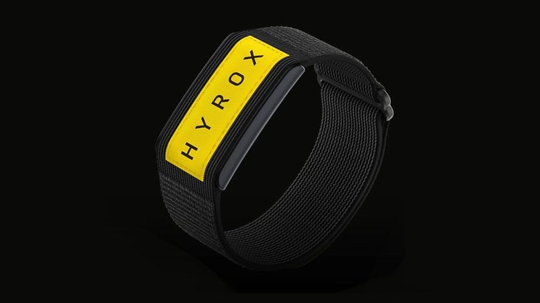 A black fitness band with a yellow label reading 'HYROX'. A black fitness band with a yellow label reading 'HYROX'.