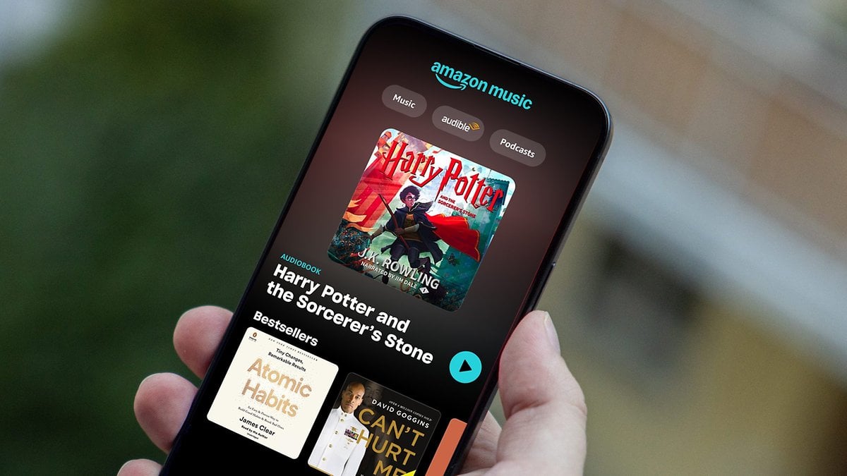 A smartphone displaying Amazon Music with the audiobook 'Harry Potter and the Sorcerer's Stone' featured.