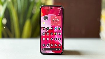 A Google Pixel 9 Pro XL smartphone displaying a colorful home screen with various app icons and a clock.