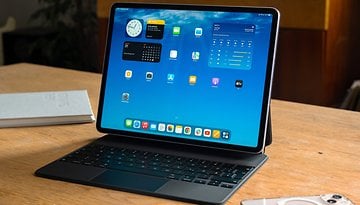 Apple iPad Air M3 on a wooden table with a keyboard and various app icons displayed on the screen.