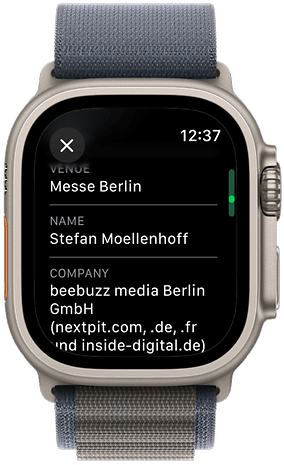 Apple Watch displaying event details: Venue: Messe Berlin, Name: Stefan Moellenhoff, Company: beebuzz media Berlin GmbH.