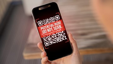 A smartphone displaying a warning QR code with text: 'POTENTIAL RISK! DO NOT SCAN!'