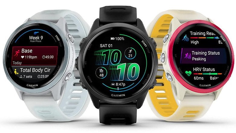 Three Garmin Forerunner 570 smartwatches displaying fitness metrics and training status. Three Garmin Forerunner 570 smartwatches displaying fitness metrics and training status.