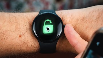A close-up of a Google Pixel Watch 2 displaying an unlocked padlock icon with a spider.