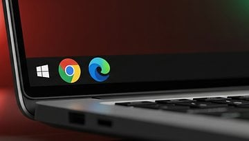 A close-up of a laptop screen showing the Windows logo and browser icons for Chrome and Edge.