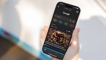 A hand holding a smartphone displaying Google News with a headline about the Philippines' Black Nazarene procession.