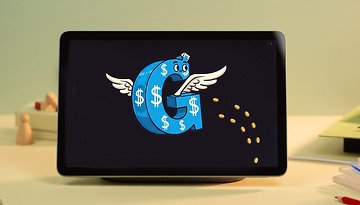 A Google Pixel tablet displays a cartoon letter 'G' with wings and dollar signs, surrounded by falling coins.